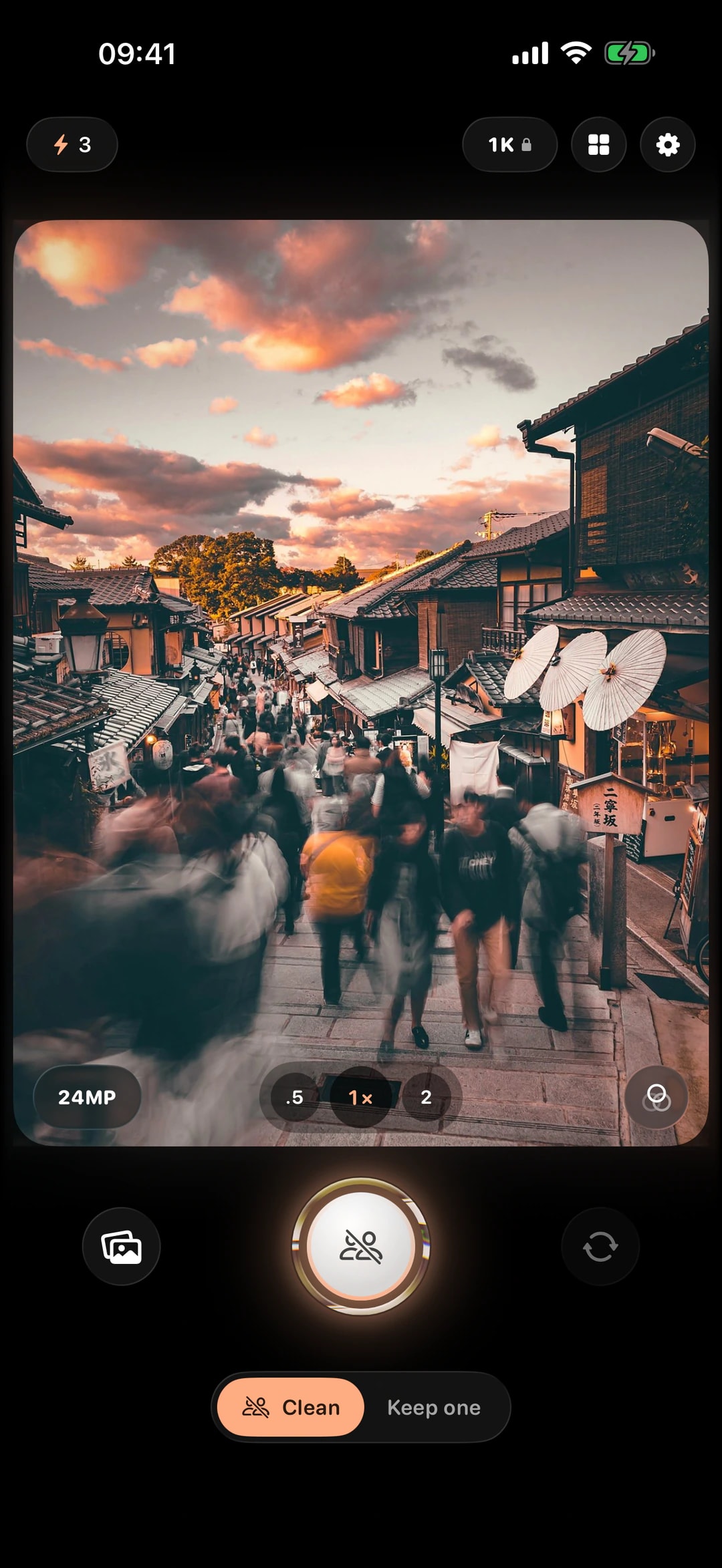 The ClearShot camera in Clean mode on a crowded street in Kyoto, with lens buttons, the shutter and the Clean and Keep one switch