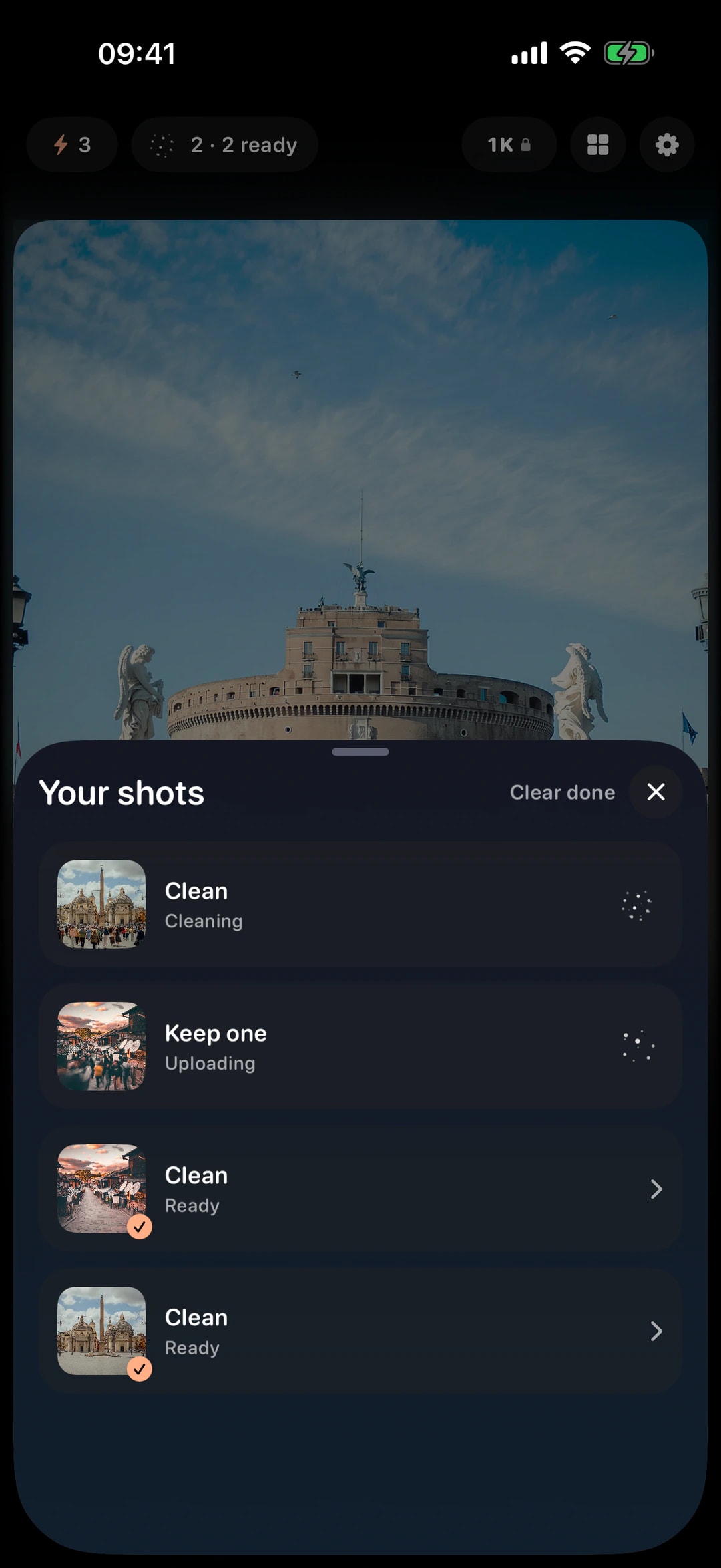 The Your shots sheet over the camera — one Clean job cleaning, a Keep one job uploading and two finished shots ready to open